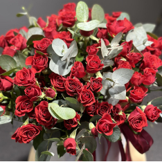 Arrangement of red bush roses in a box photo