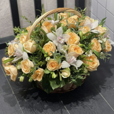 Basket with rose and orchid in assortment photo